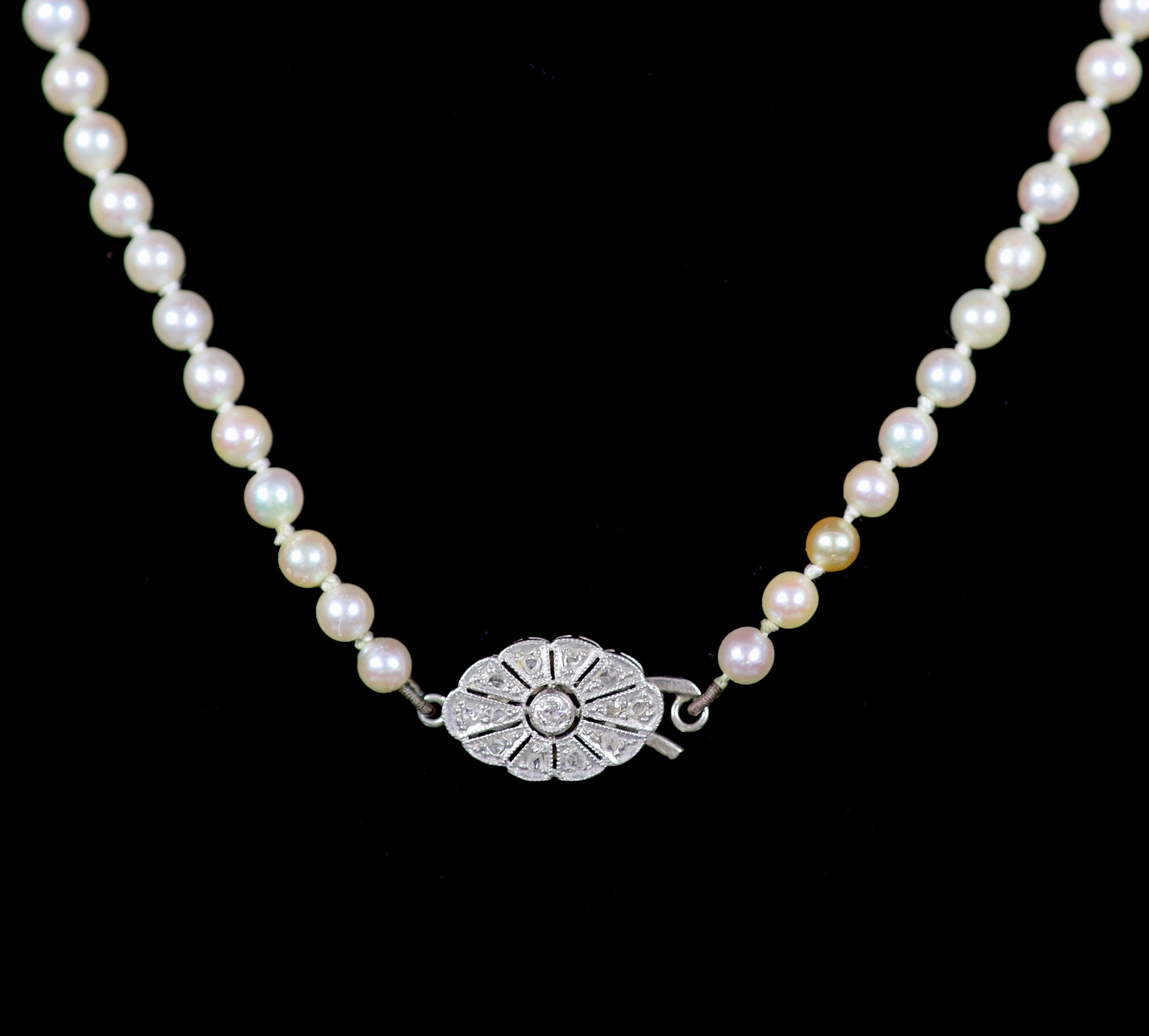 An early 20th century graduated pearl necklace, with platinum and millegrain set diamond clasp